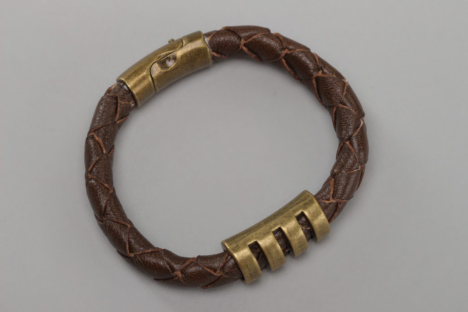 Handmade wrist bracelet woven of brown genuine leather with metal inserts photo 2