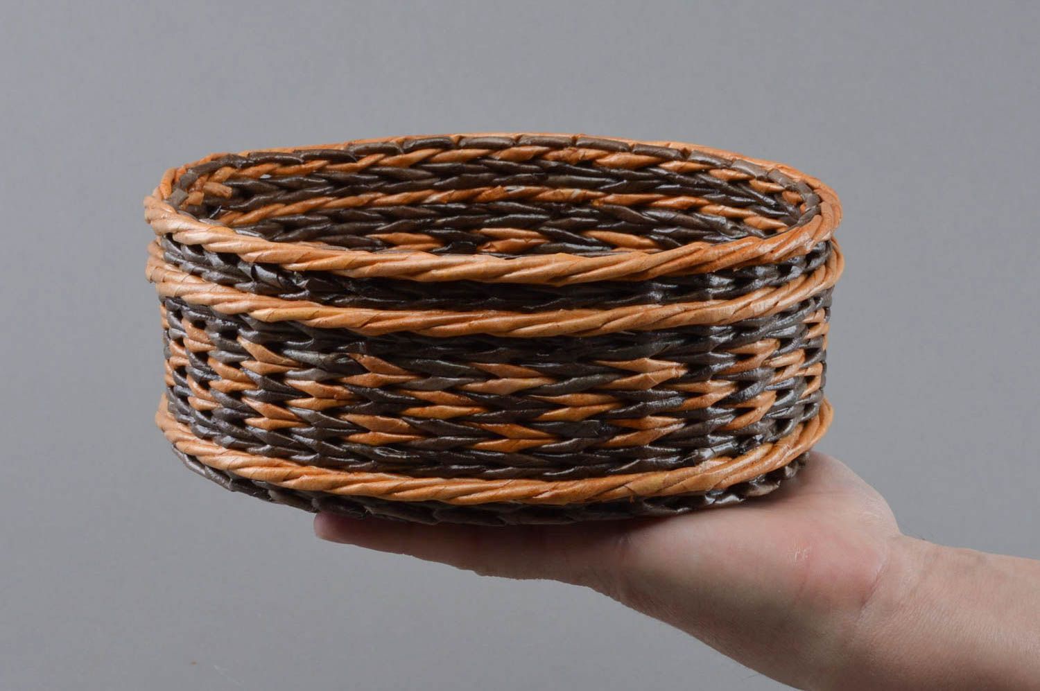 Handmade decorative round two colored brown basket woven of paper tubes photo 4