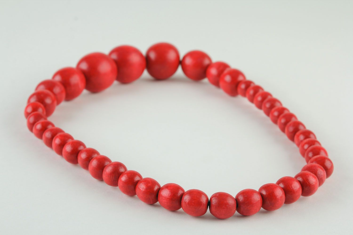 Red necklace made of large beads photo 2