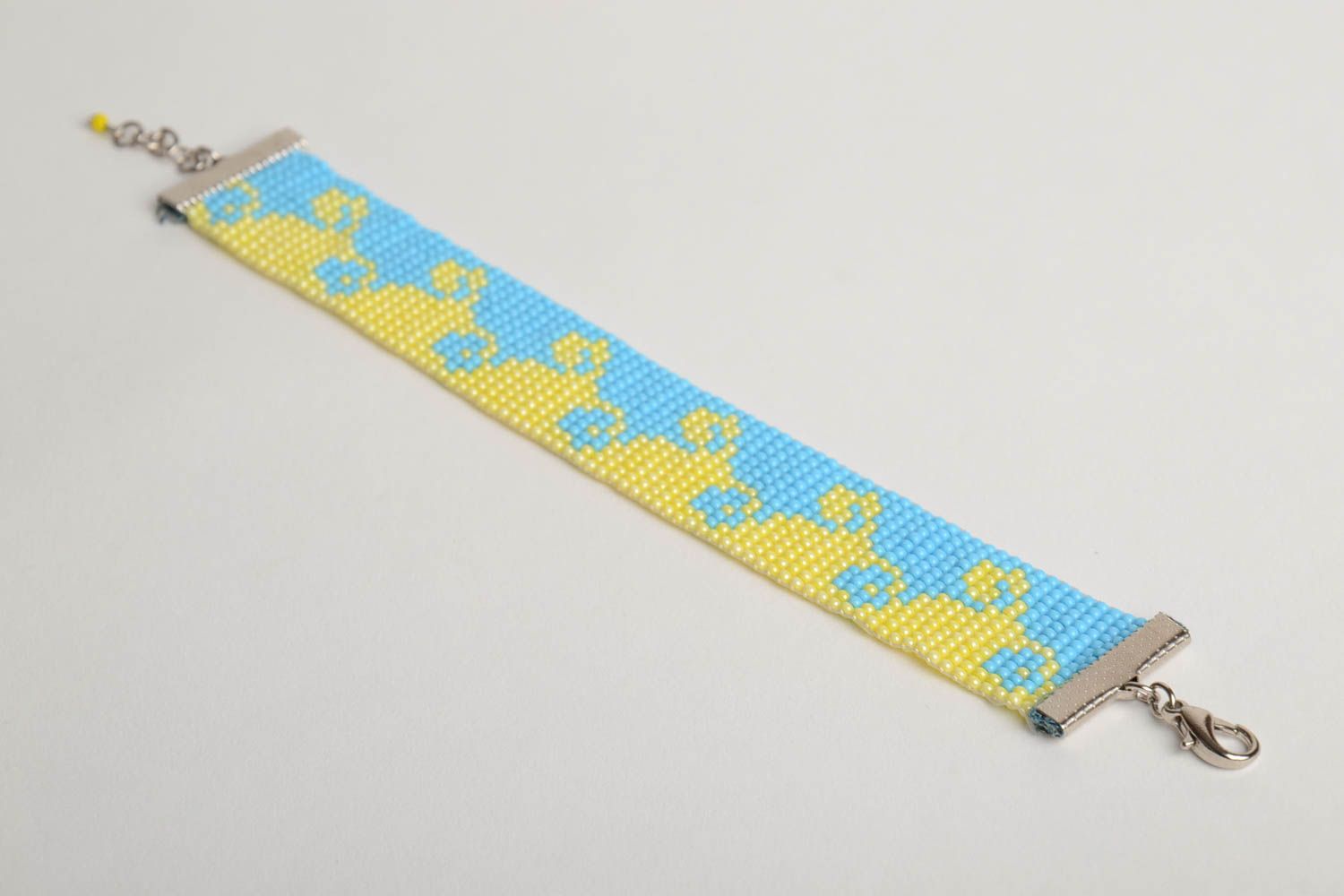 Handmade wide flat bead woven wrist bracelet with blue and yellow ornament photo 5