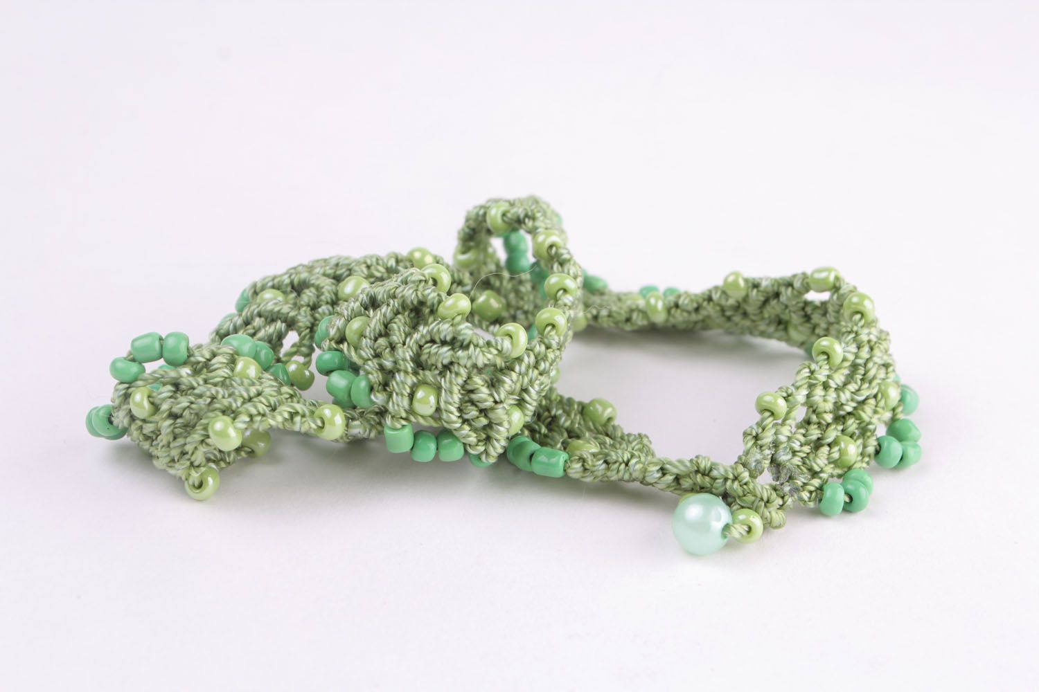 Green necklace made of threads and beads photo 5