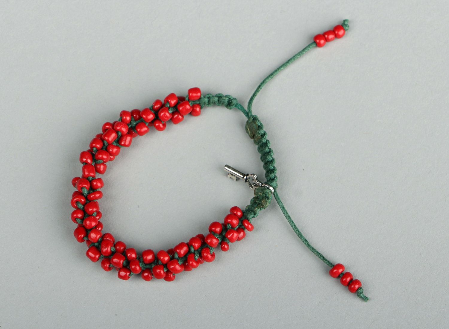 Red bracelet with beads photo 3