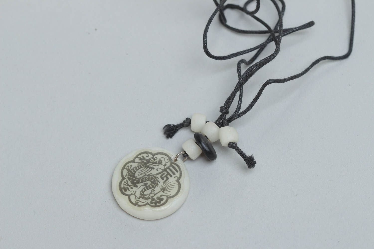 Handmade designer round pendant made of polymer clay with ethnic pattern on cord photo 2