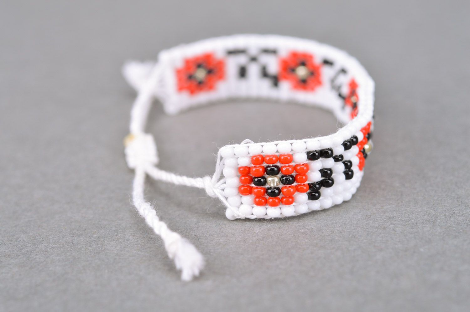 Handmade wrist bracelet woven of black white and red beads with ethnic ornament photo 5