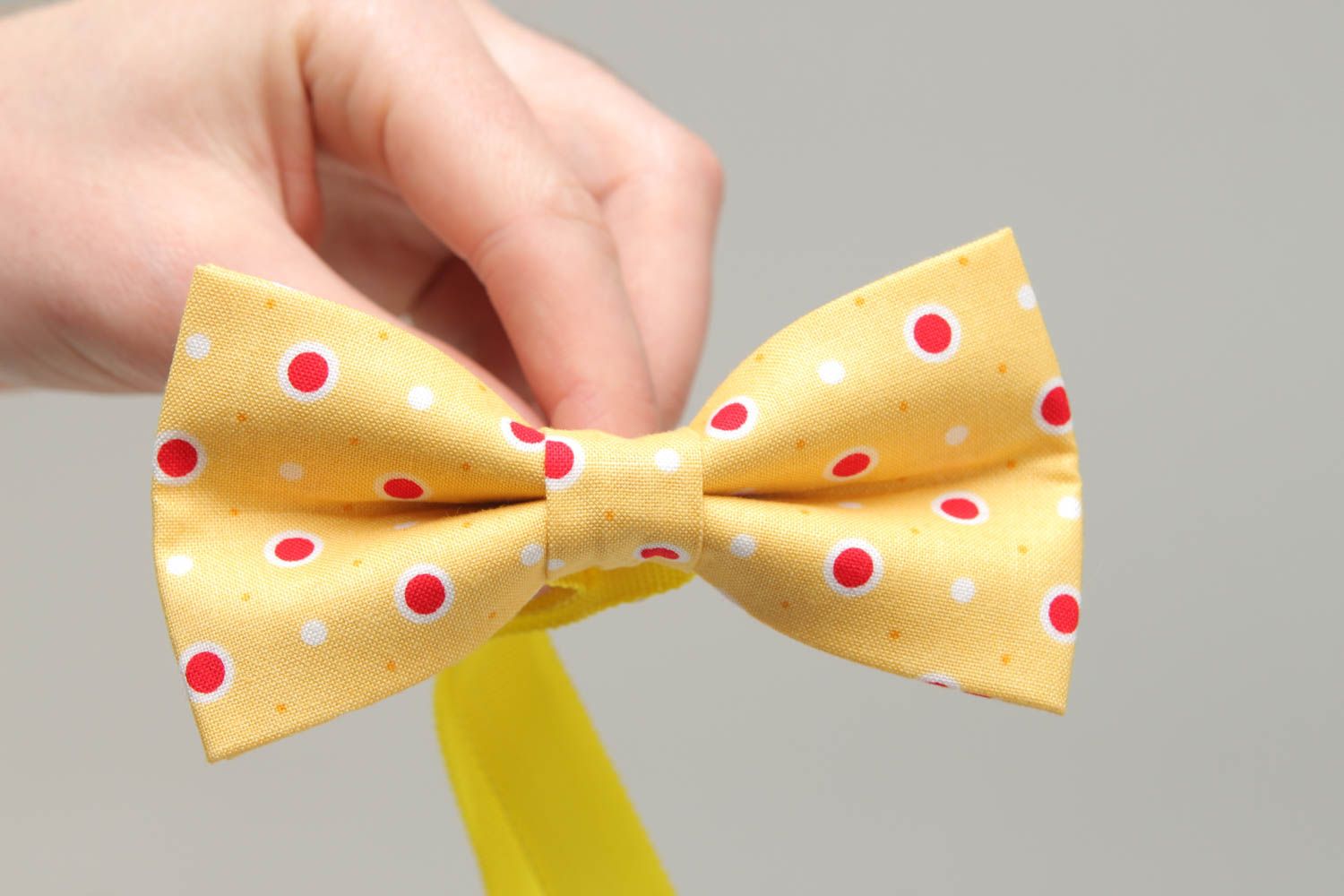 Bow tie made of yellow polka dot fabric photo 4