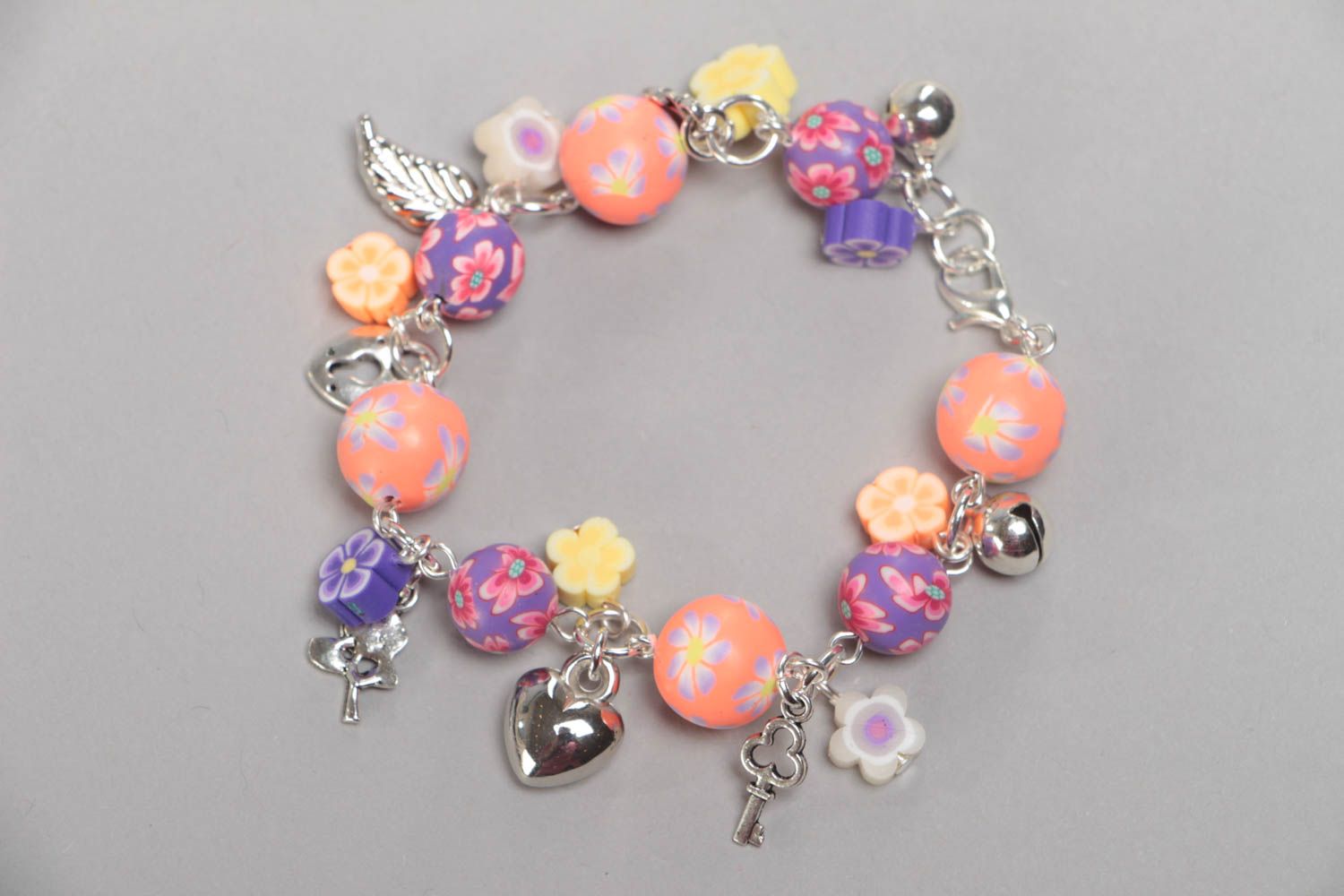 Unusual colorful handmade children's plastic wrist bracelet with charms photo 3