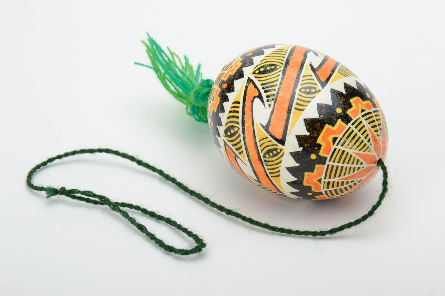 Handmade traditional wax painted colorful Easter egg with green tassel photo 2
