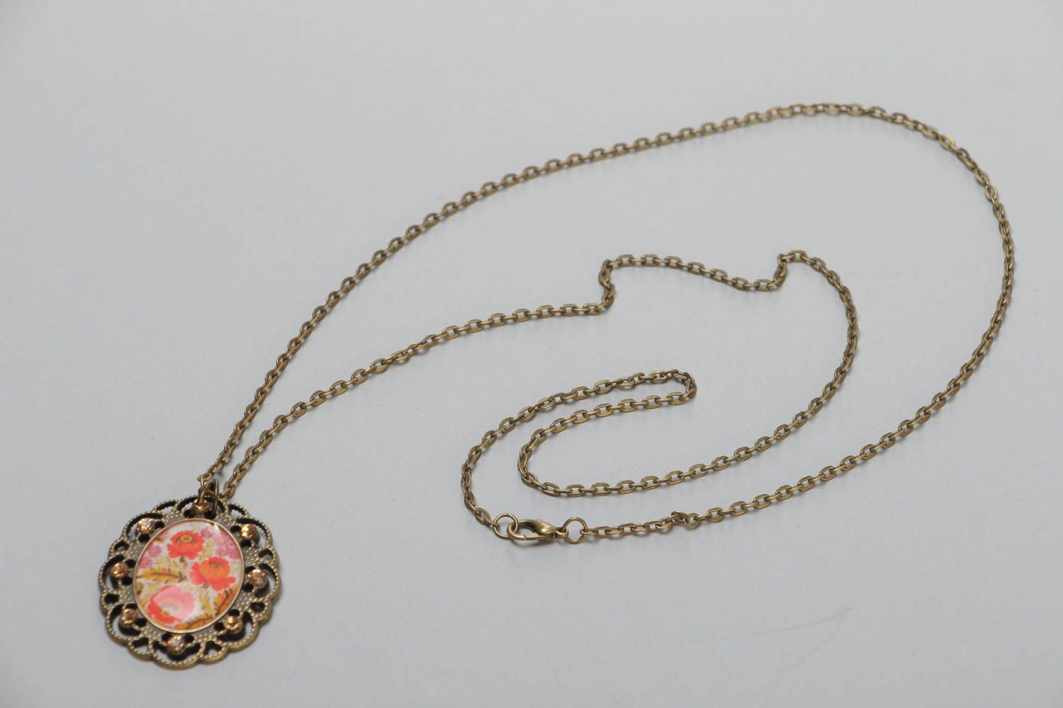 Handmade vintage metal pendant with floral image and glass glaze on chain 700 mm photo 2