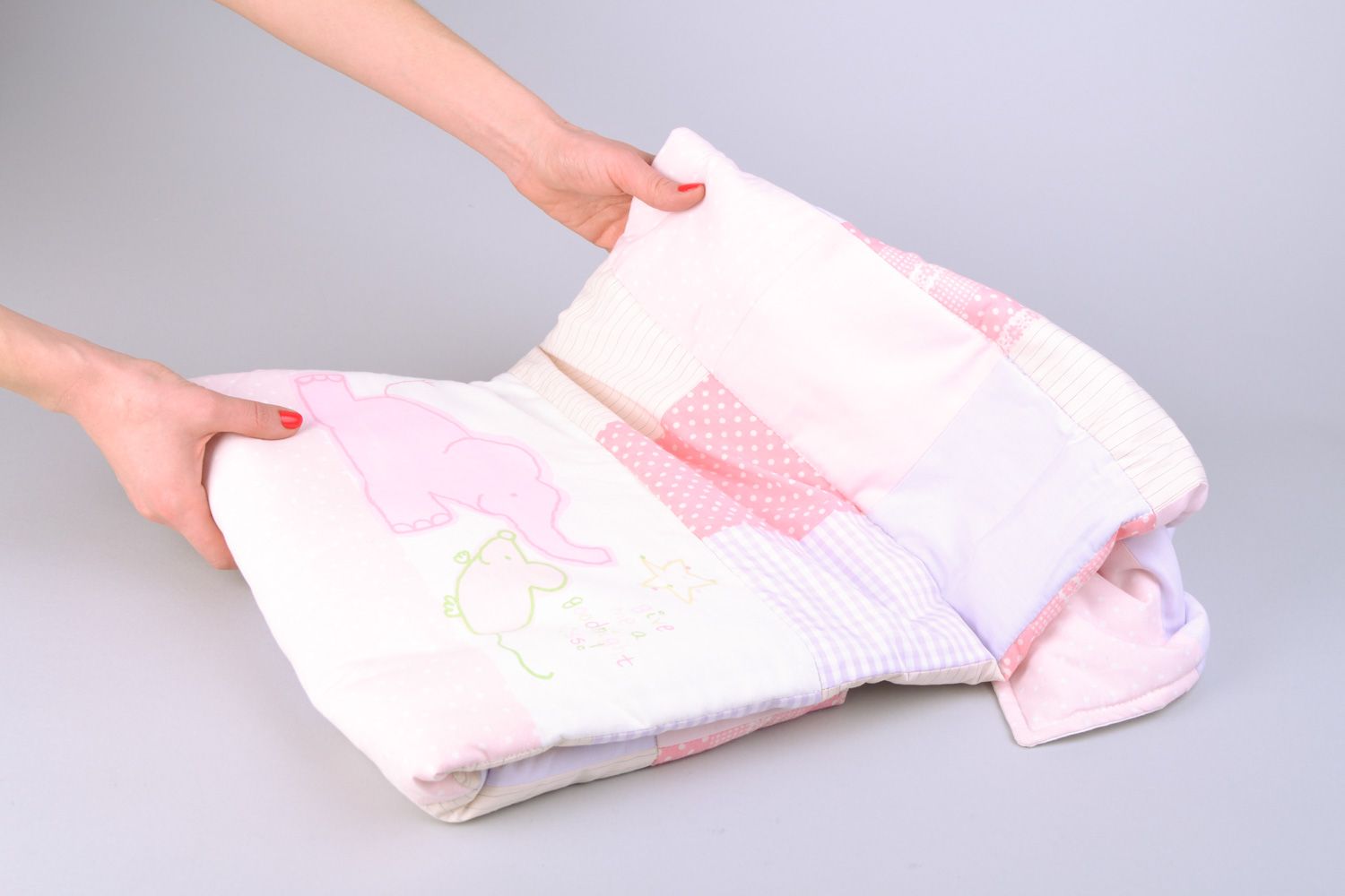 Handmade newborn baby blanket sewn of cotton fabric using patchwork technique photo 2