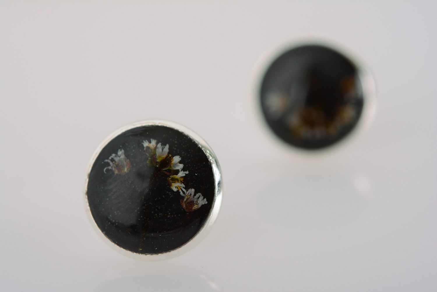 Homemade small black stud earrings with dried flower embedded in epoxy resin photo 2