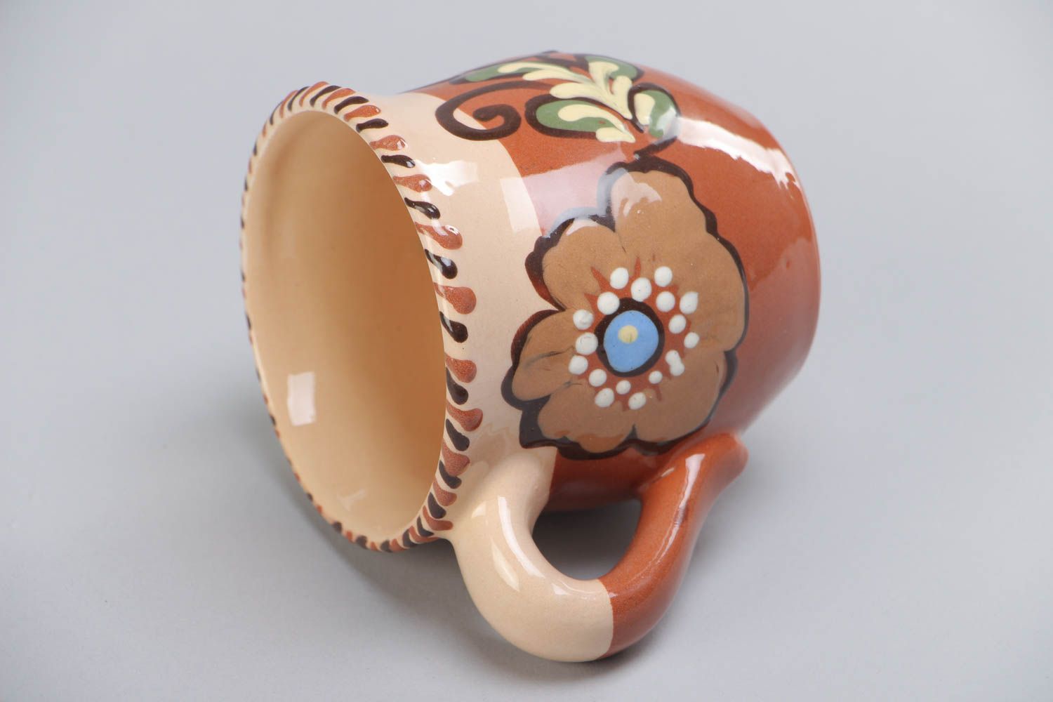 Decorative clay cup with handle and floral pattern in brown and beige color photo 4