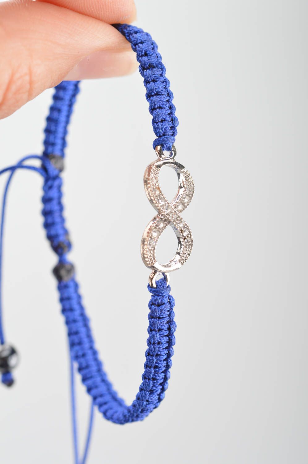 Handmade stylish thin blue woven wrist bracelet made of silk with insert photo 3