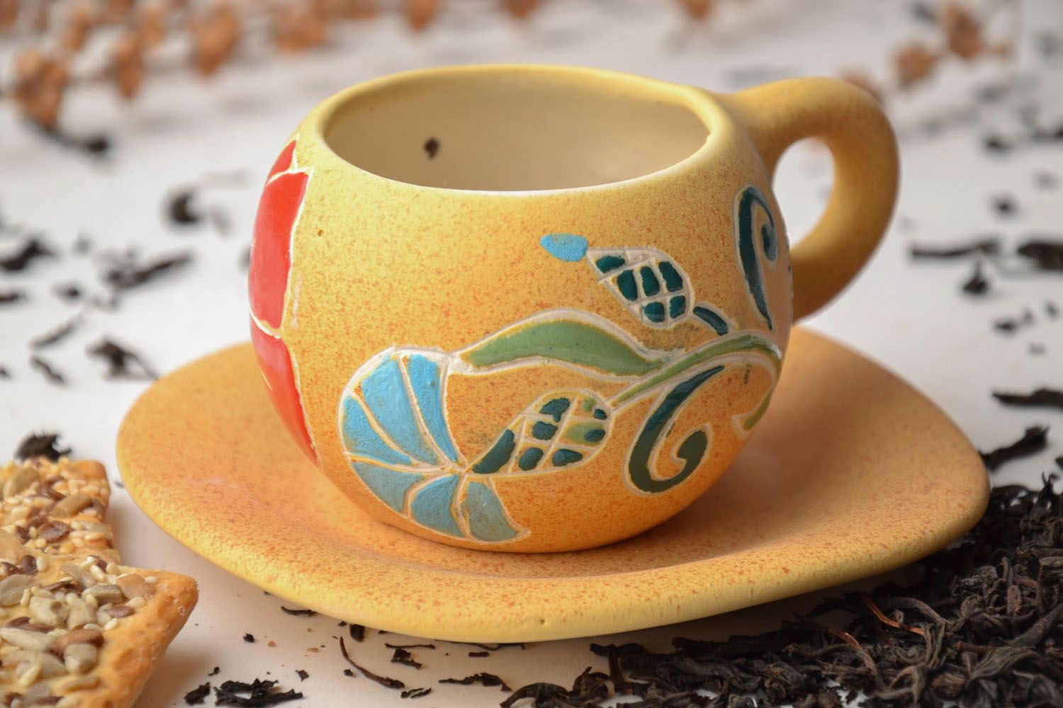 Clay yellow drinking cup with floral pattern with handle and saucer  photo 1