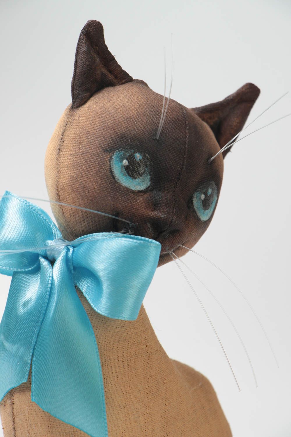 Handmade designer soft toy sewn of primed fabric beautiful cat with blue bow photo 3