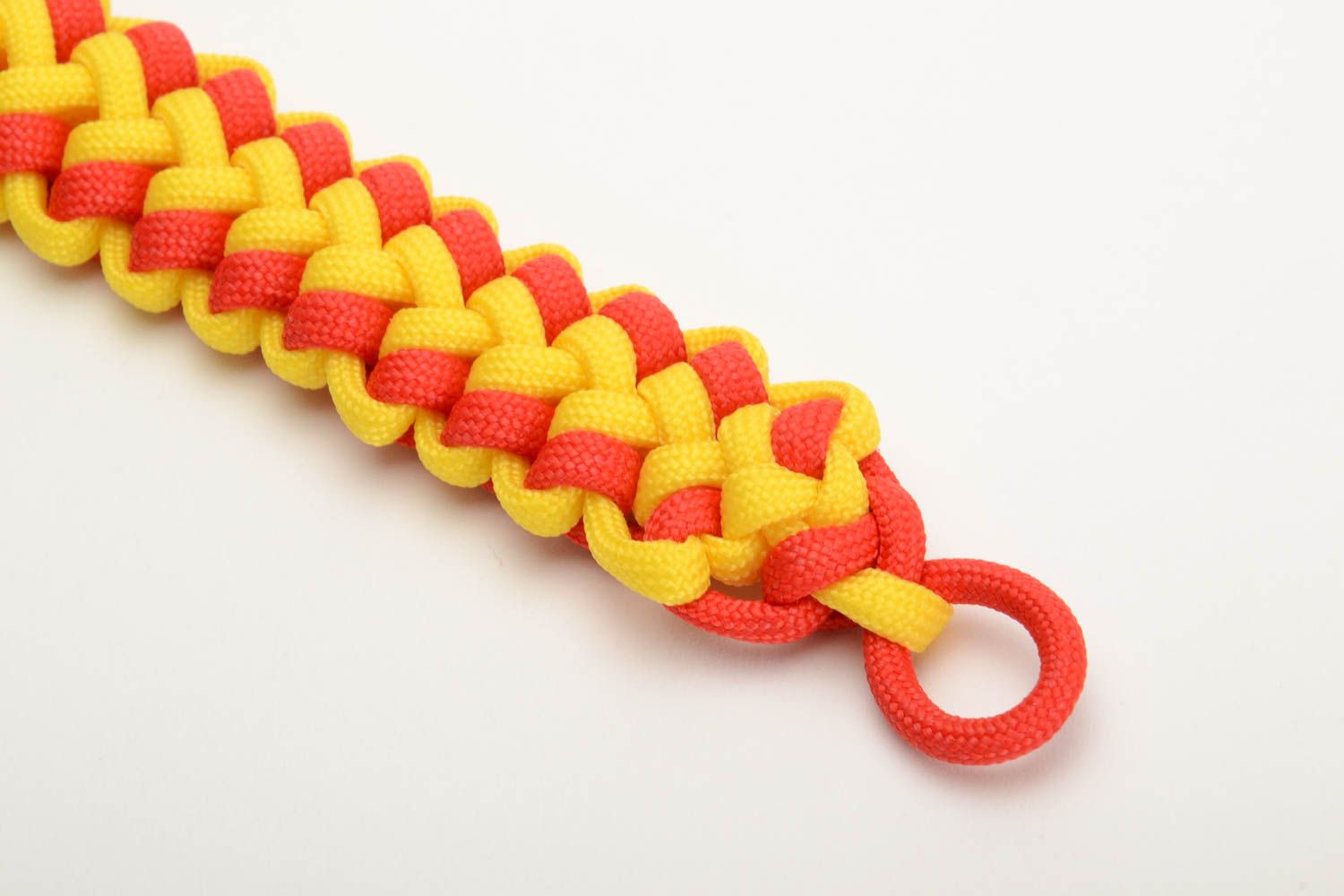 Red and yellow handmade wrist bracelet woven of American paracord photo 2