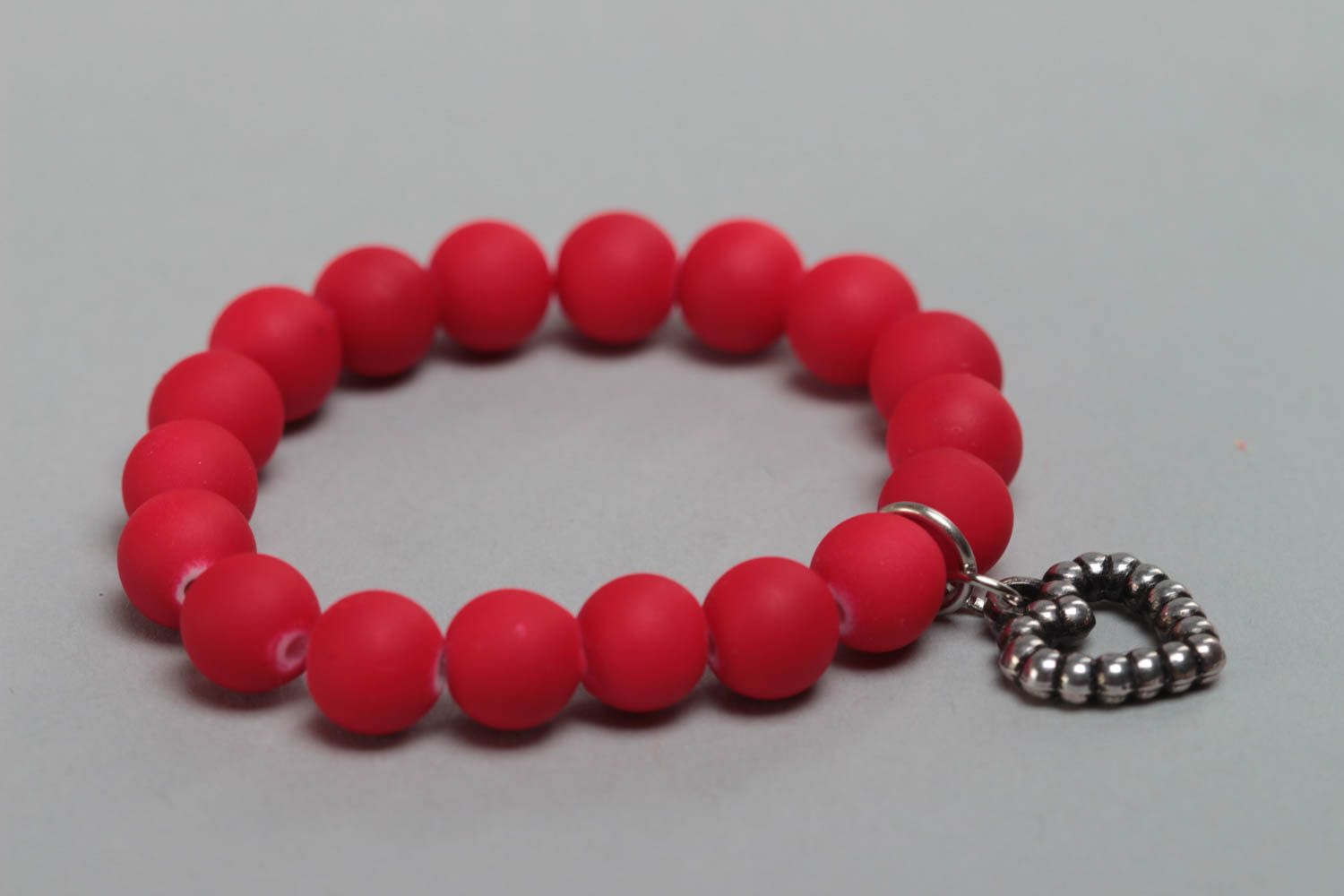 Red handmade children's wrist bracelet with plastic beads and heart charm photo 2