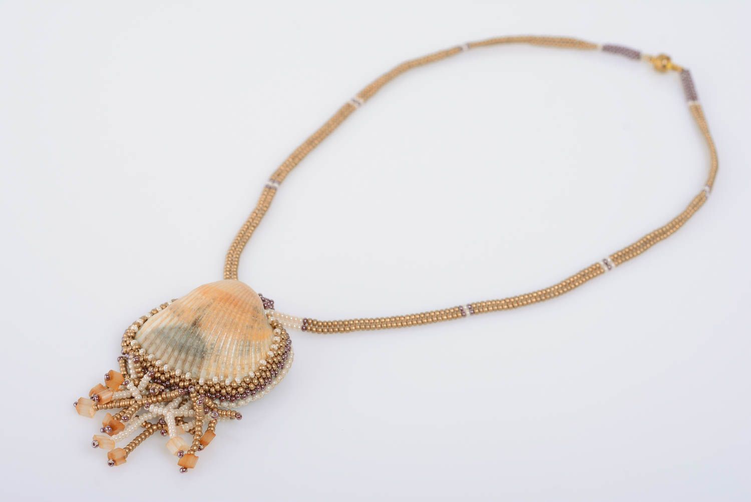 Unusual handmade women's designer beige beaded pendant with seashell photo 1