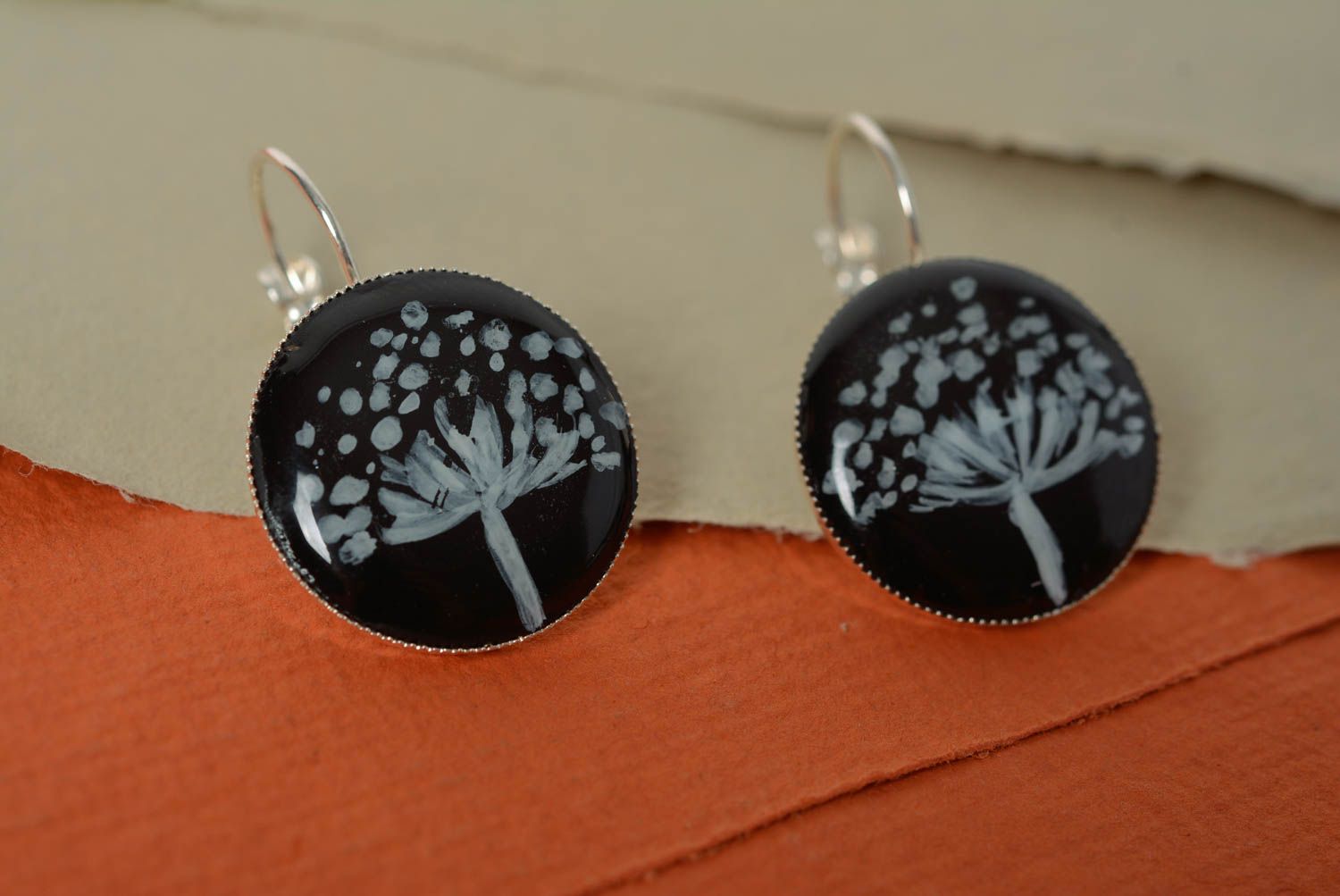 Round-shaped black handmade earrings made of epoxy resin with picture inside photo 1