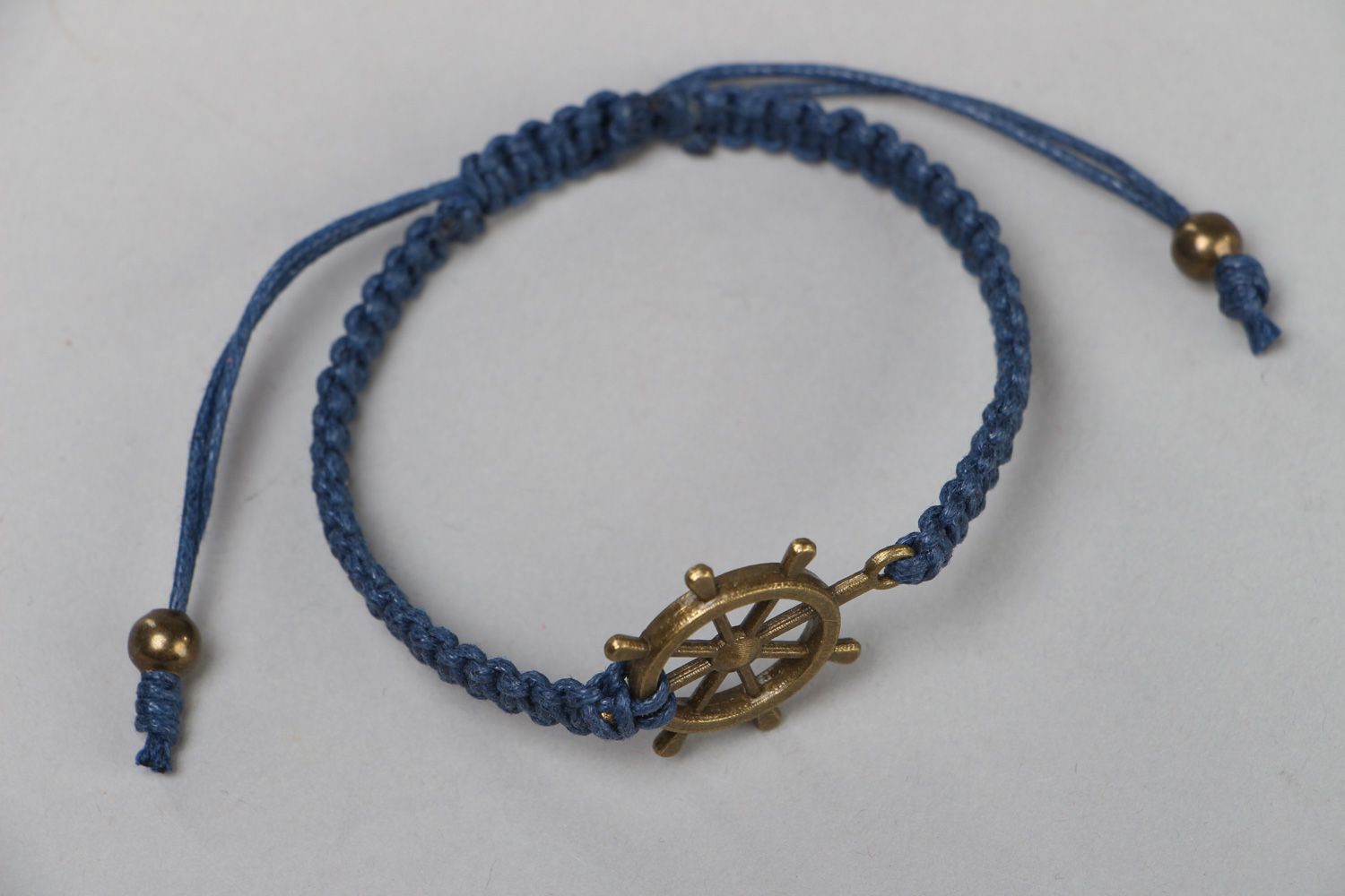 Handmade wrist bracelet woven of blue waxed cord with metal wheel unisex  photo 2