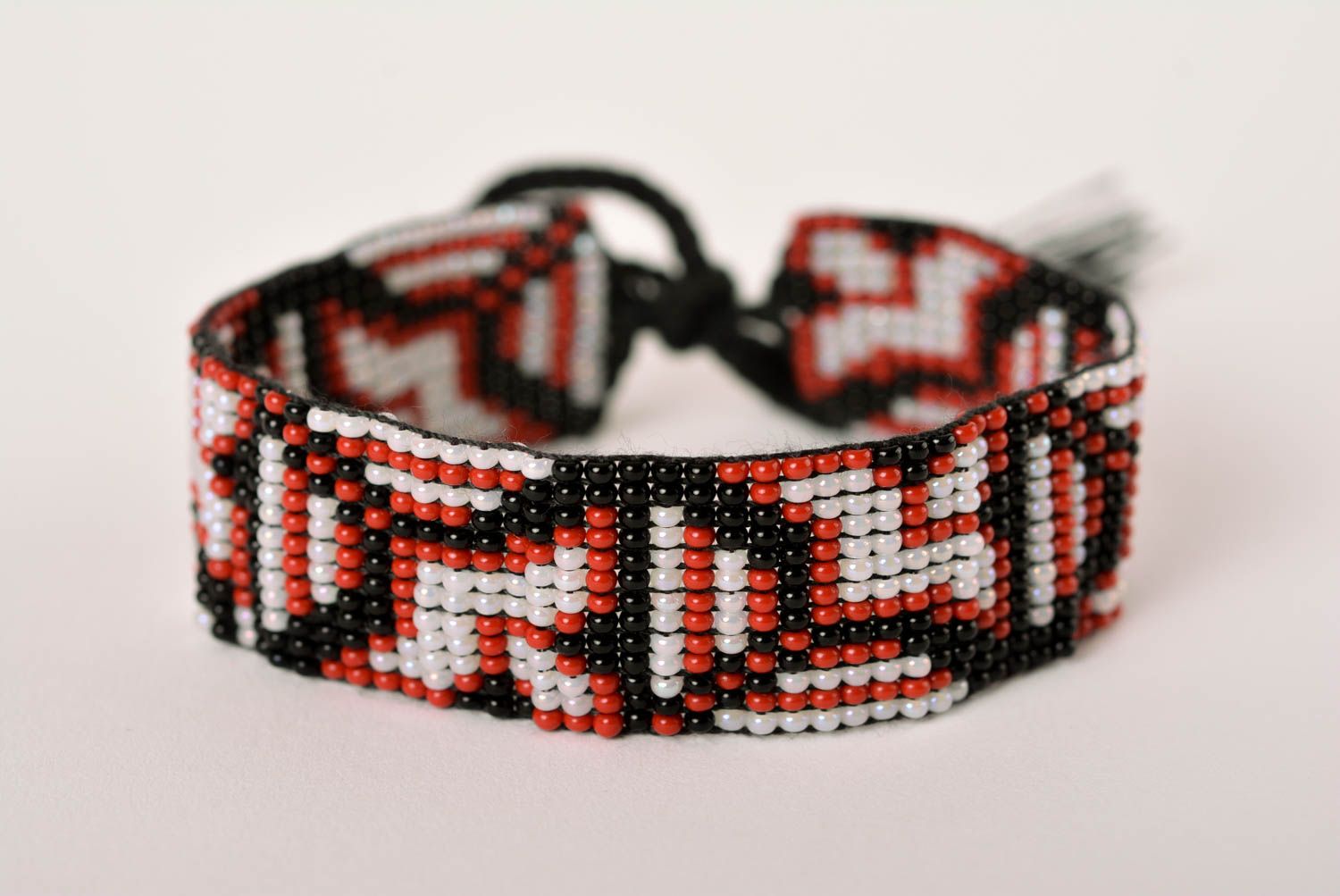 Handmade geometrical ornament beaded bracelet in black, red, gray color photo 1
