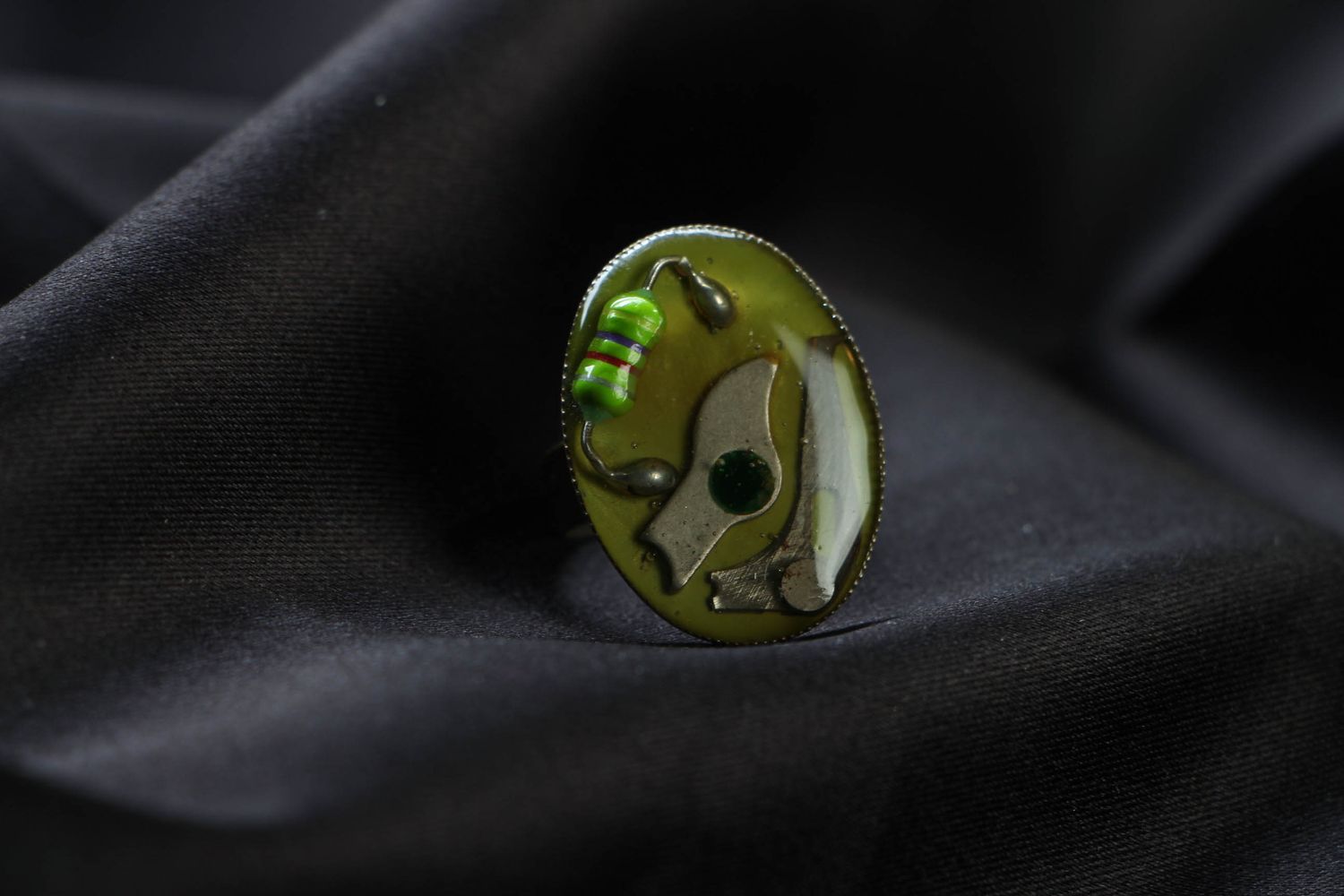 Green metal ring in steampunk and techno style photo 2