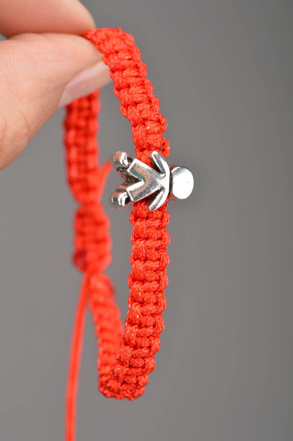 Thin woven stylish unusual red handmade bracelet made of textile laces Man photo 2
