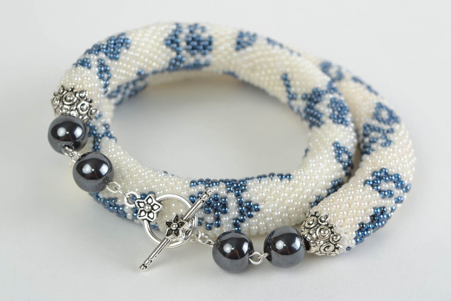 Beautiful handmade beaded cord necklace white with blue patterns photo 3
