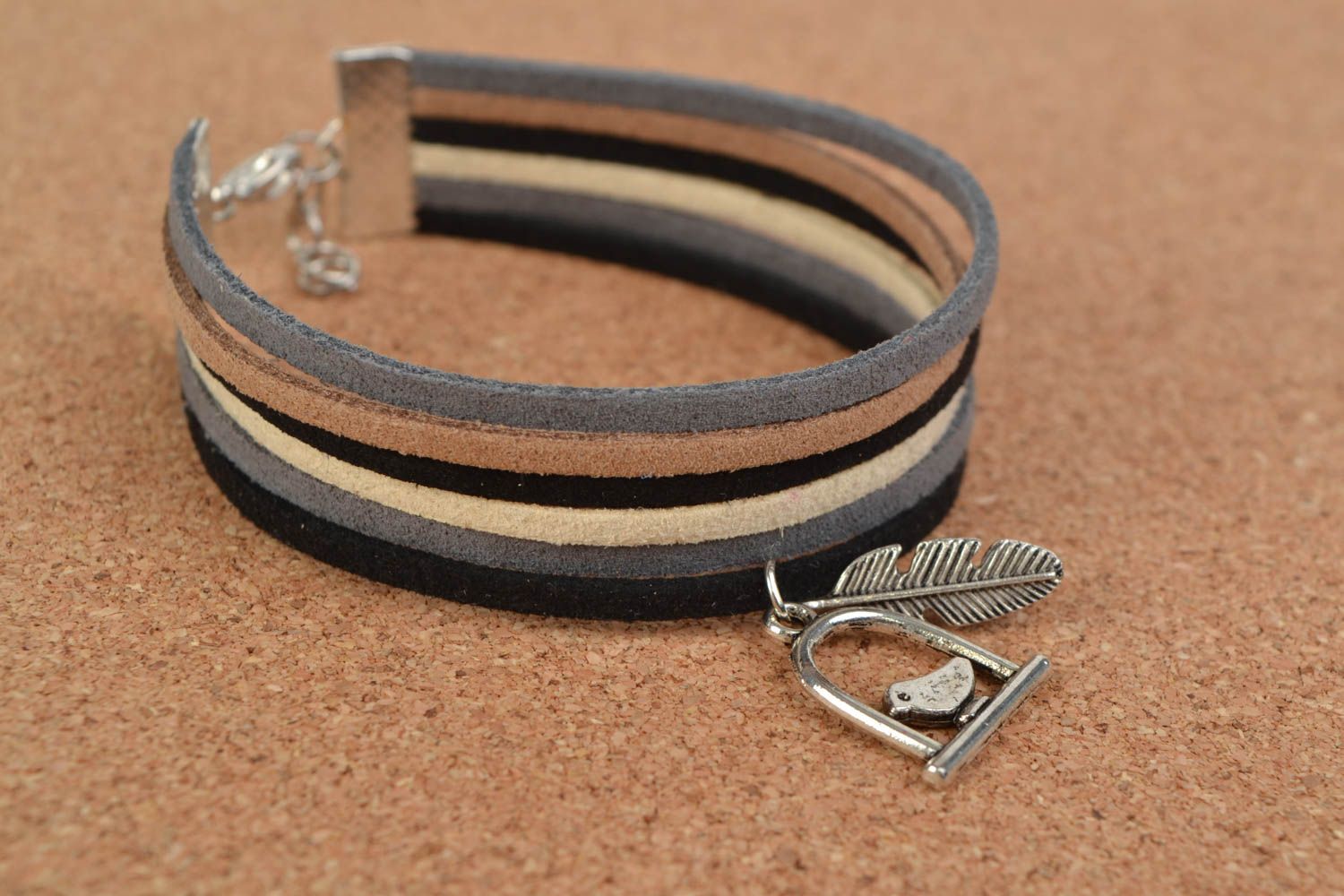 Homemade woven suede bracelet with metal charm in the shape of bird and feather photo 1