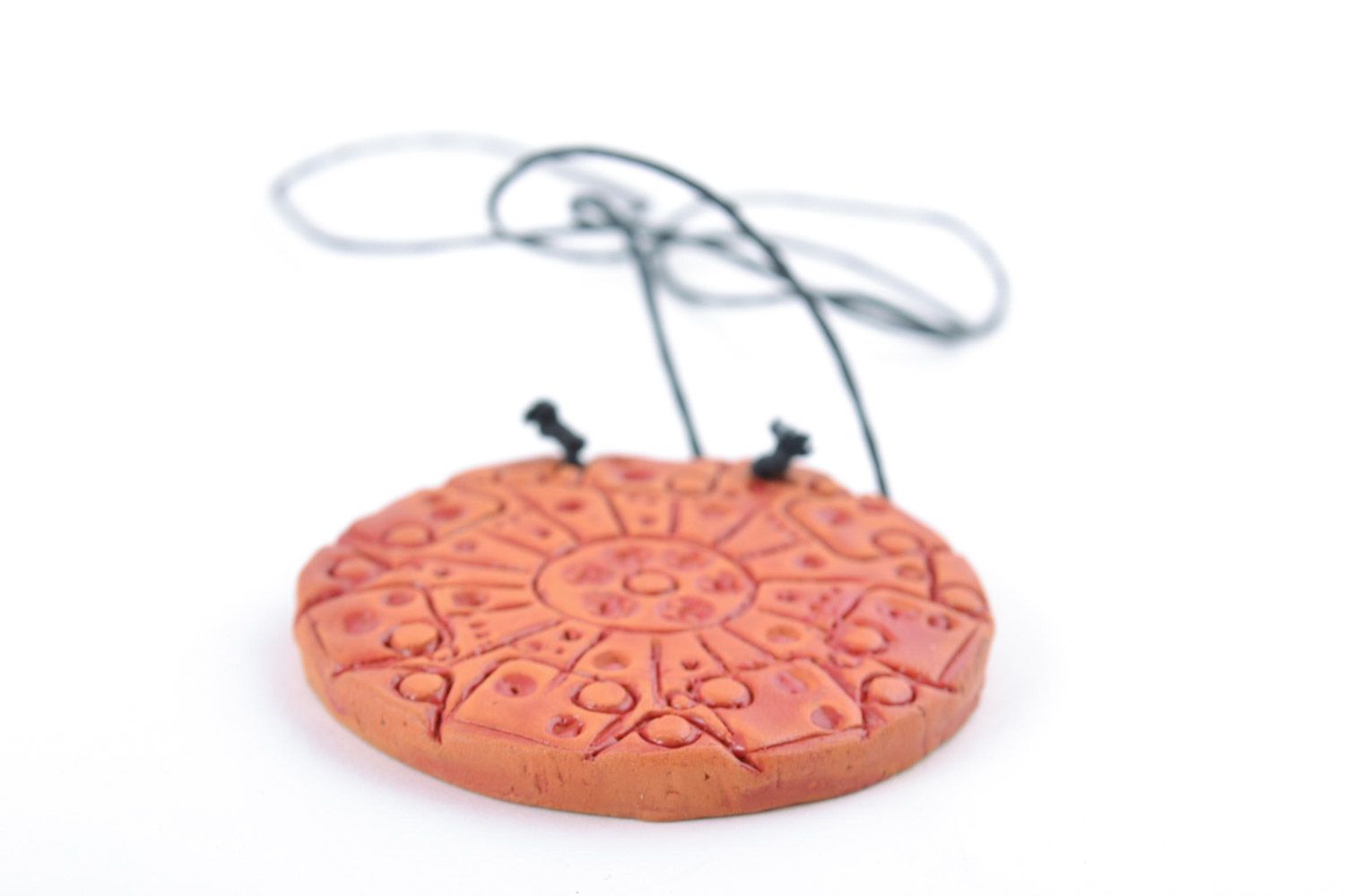 Handmade bright orange ceramic pendant of round shape with ornament on cord photo 3