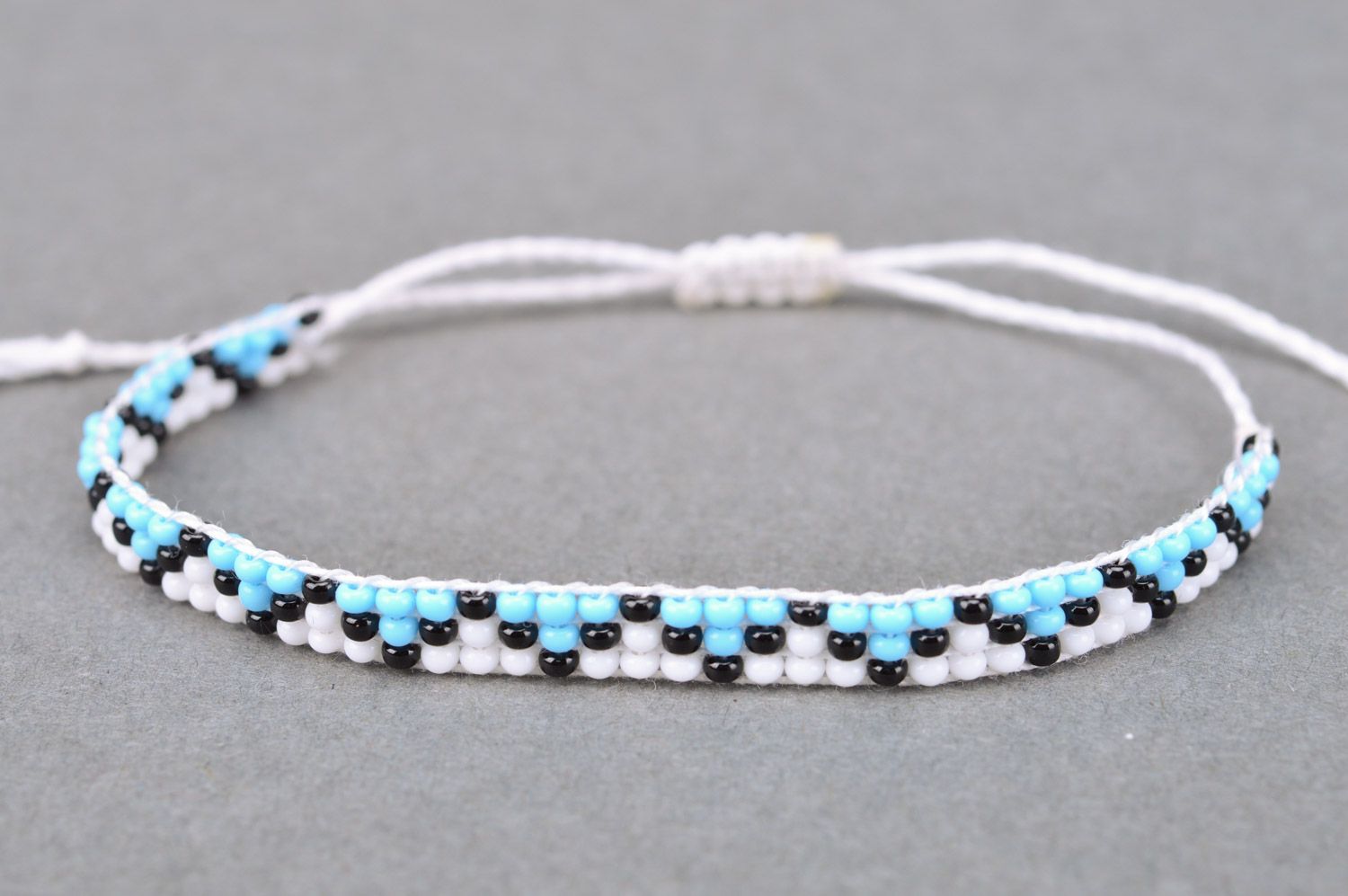 Handmade light thin wrist bracelet woven of beads and threads with ornament photo 5