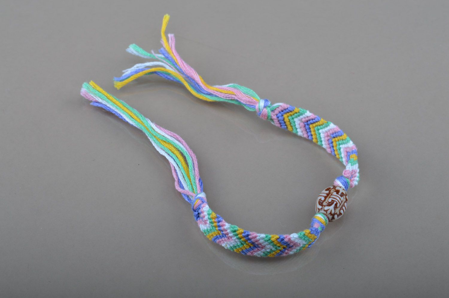 Simple handmade friendship bracelet woven of colorful embroidery floss with beads photo 2