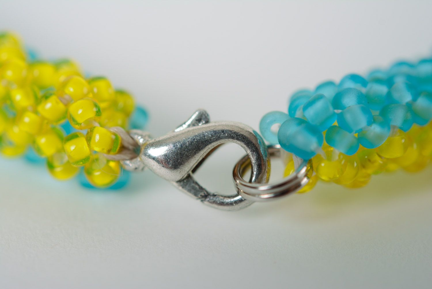 Thin handmade wrist bracelet woven of yellow and blue beads in Ukrainian style photo 3