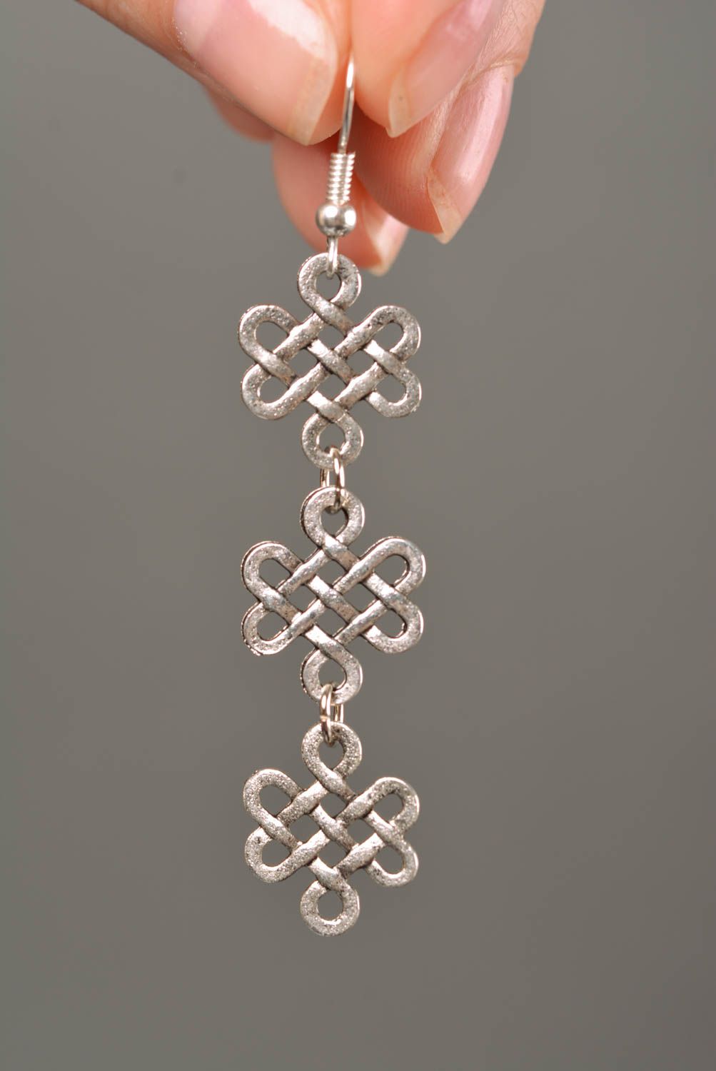 Handmade long designer metal dangle earrings of silver color in ethnic style photo 2