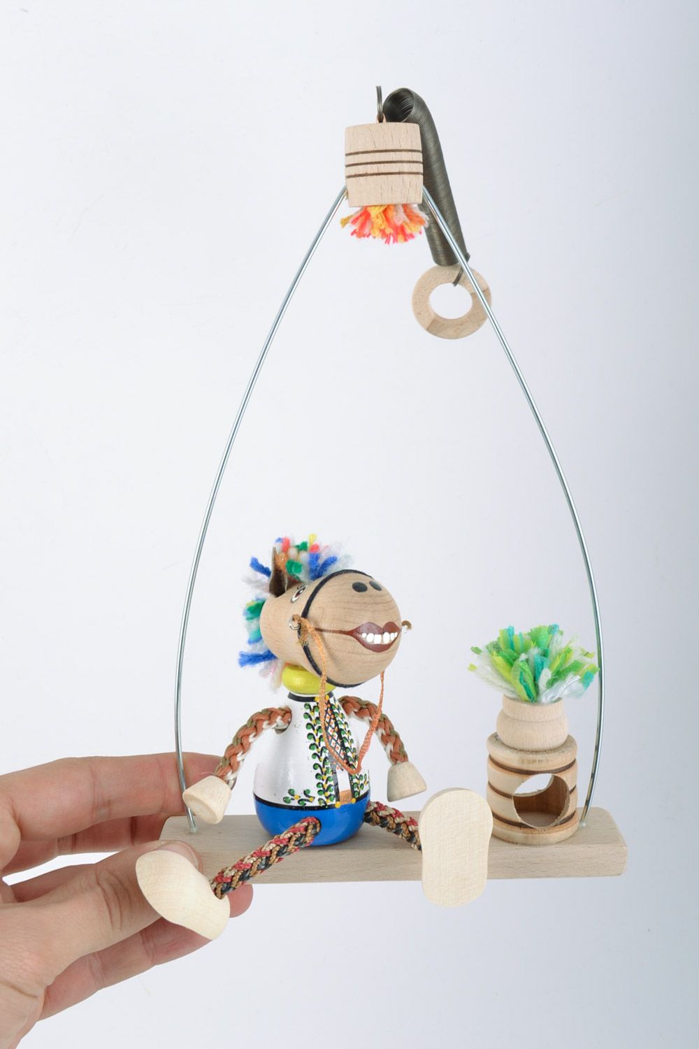 Handmade eco friendly painted wooden toy for kids and interior horse on swing photo 2