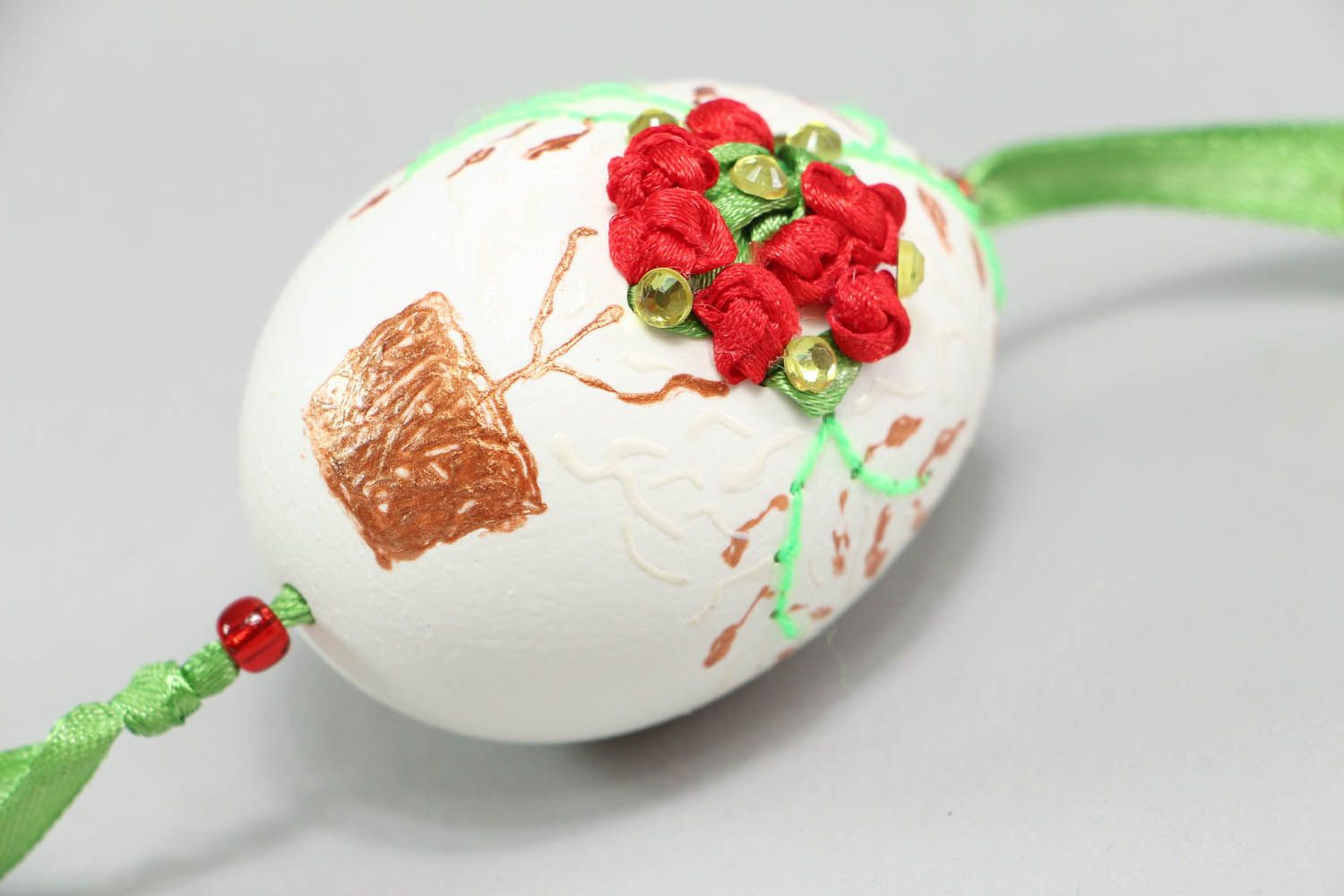 Pingente para a casa na forma de ovo esculpido decorado com fitas bordadas e pintado à mão foto 2