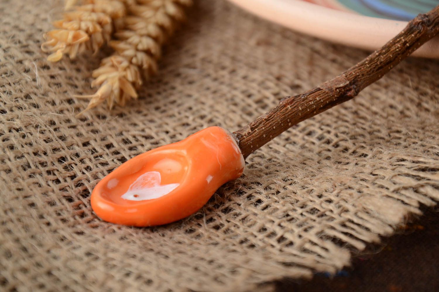 Orange handmade designer spoon created of clay and apricot tree branch photo 1