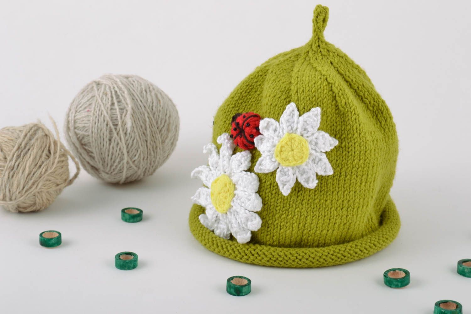 Handmade bright green hat knitted of cotton threads with chamomiles and ladybug photo 1