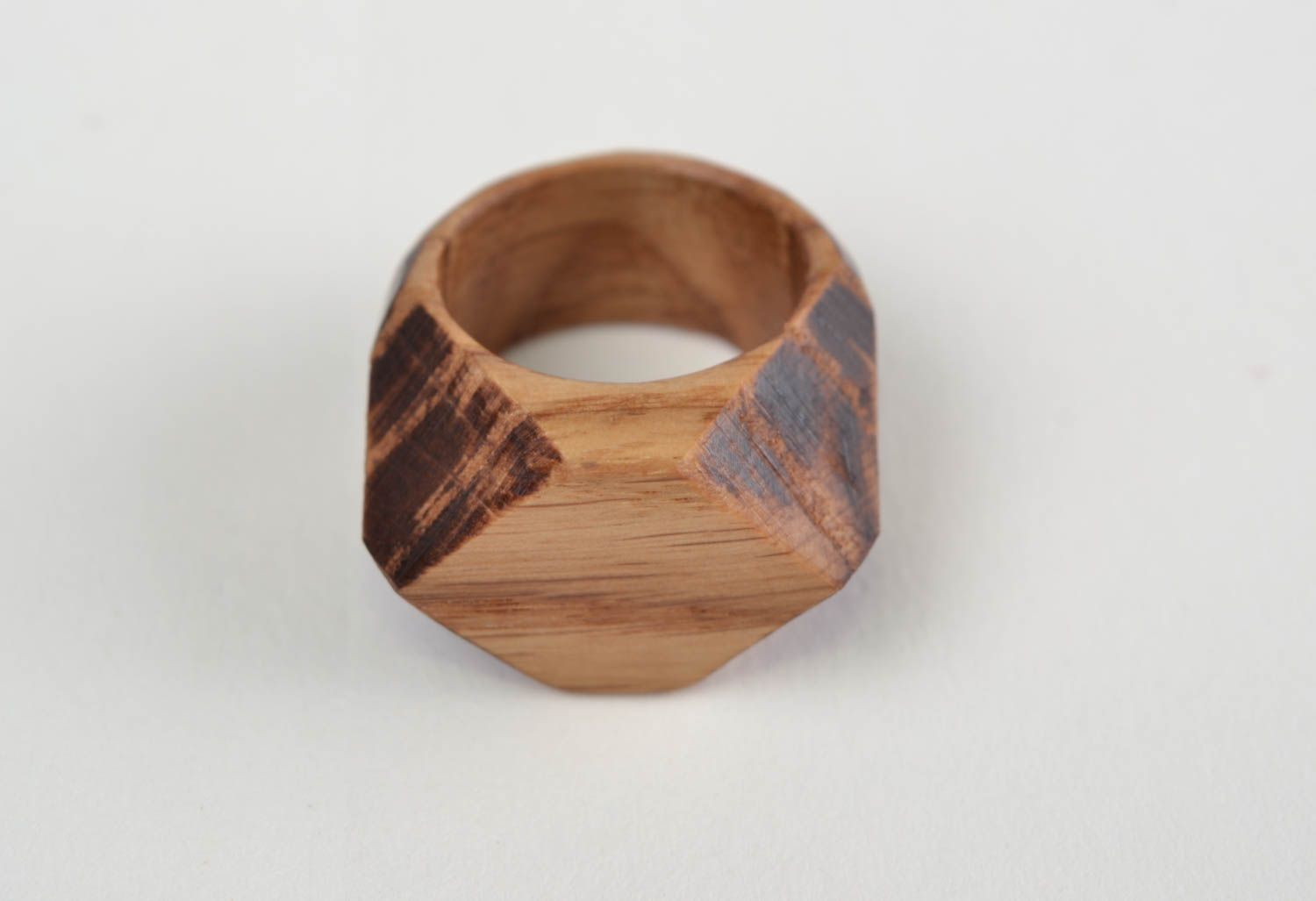 Handmade stylish designer jewelry ring cut out of natural oak wood with facets photo 4