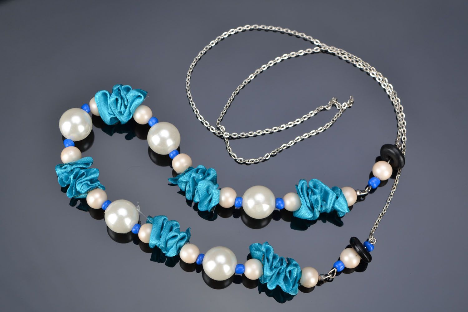 Beautiful necklace made of beads and satin photo 1