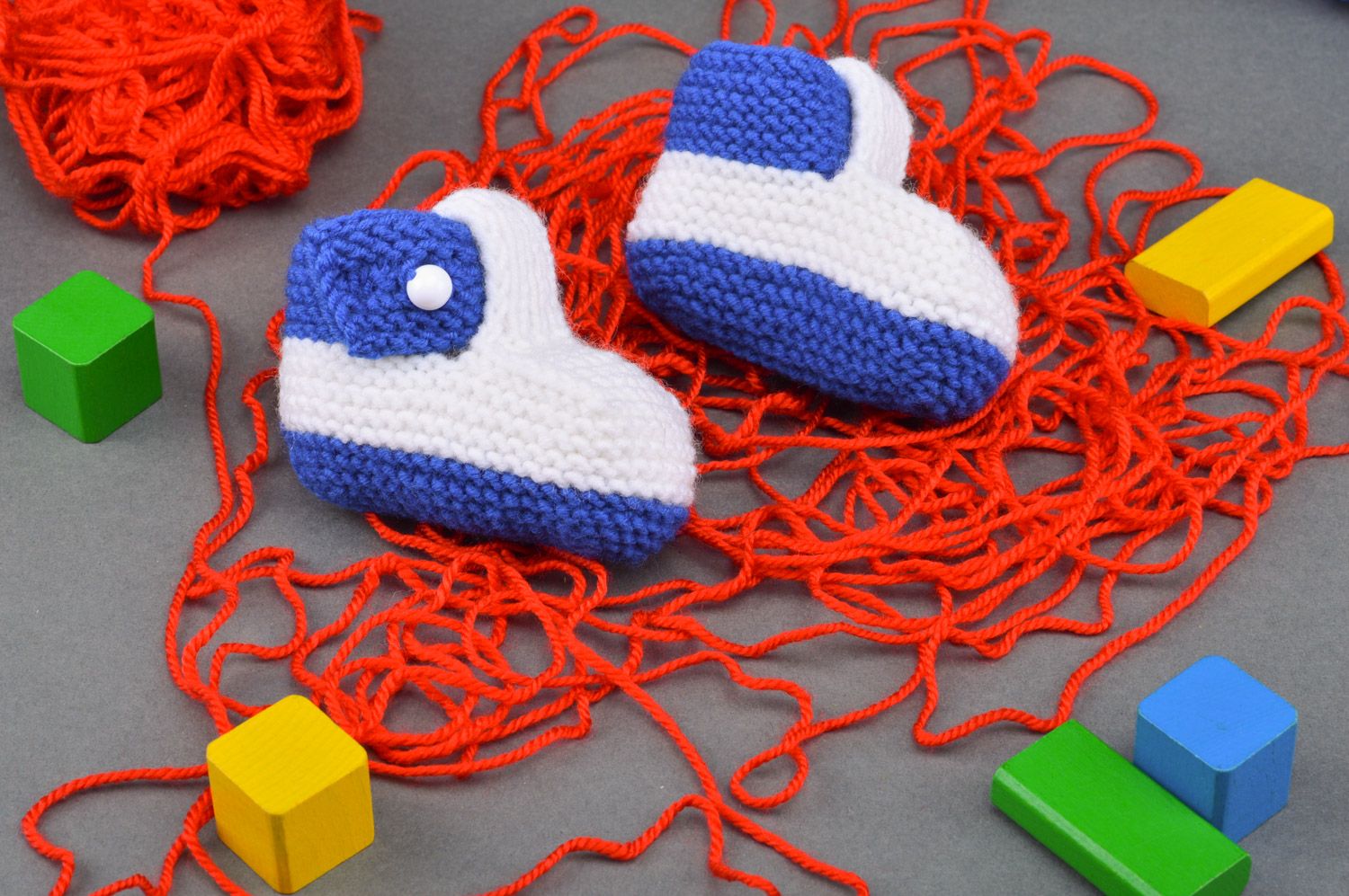Small handmade knitted baby booties of white and blue colors for boy photo 1