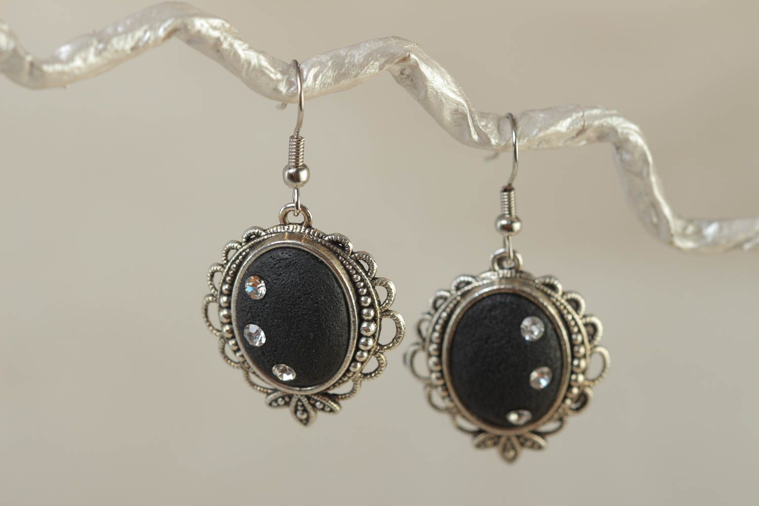 Black handmade oval polymer clay earrings in metal frame photo 1