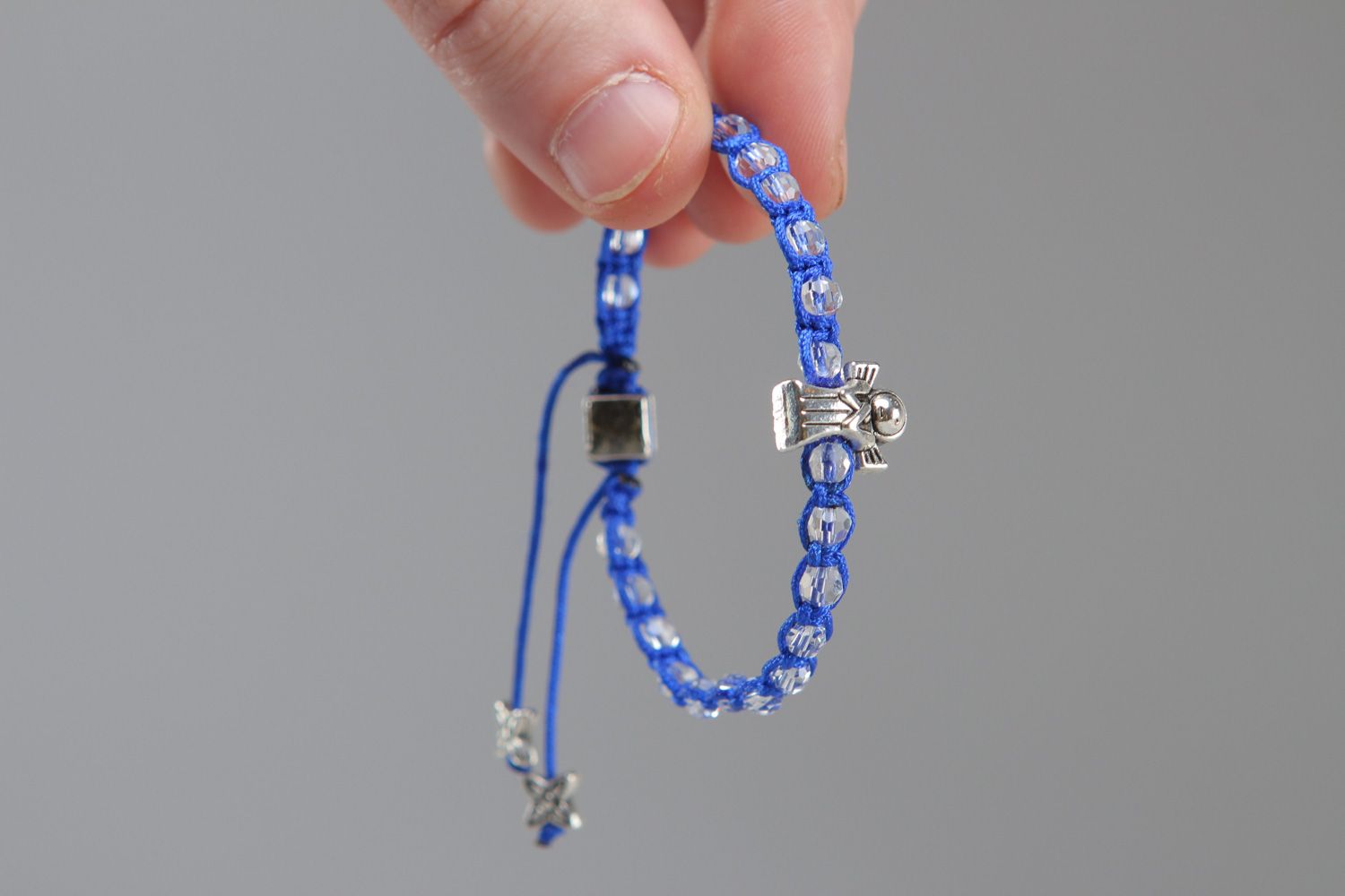 Handmade friendship wrist bracelet woven of blue cord with beads and metal element photo 3