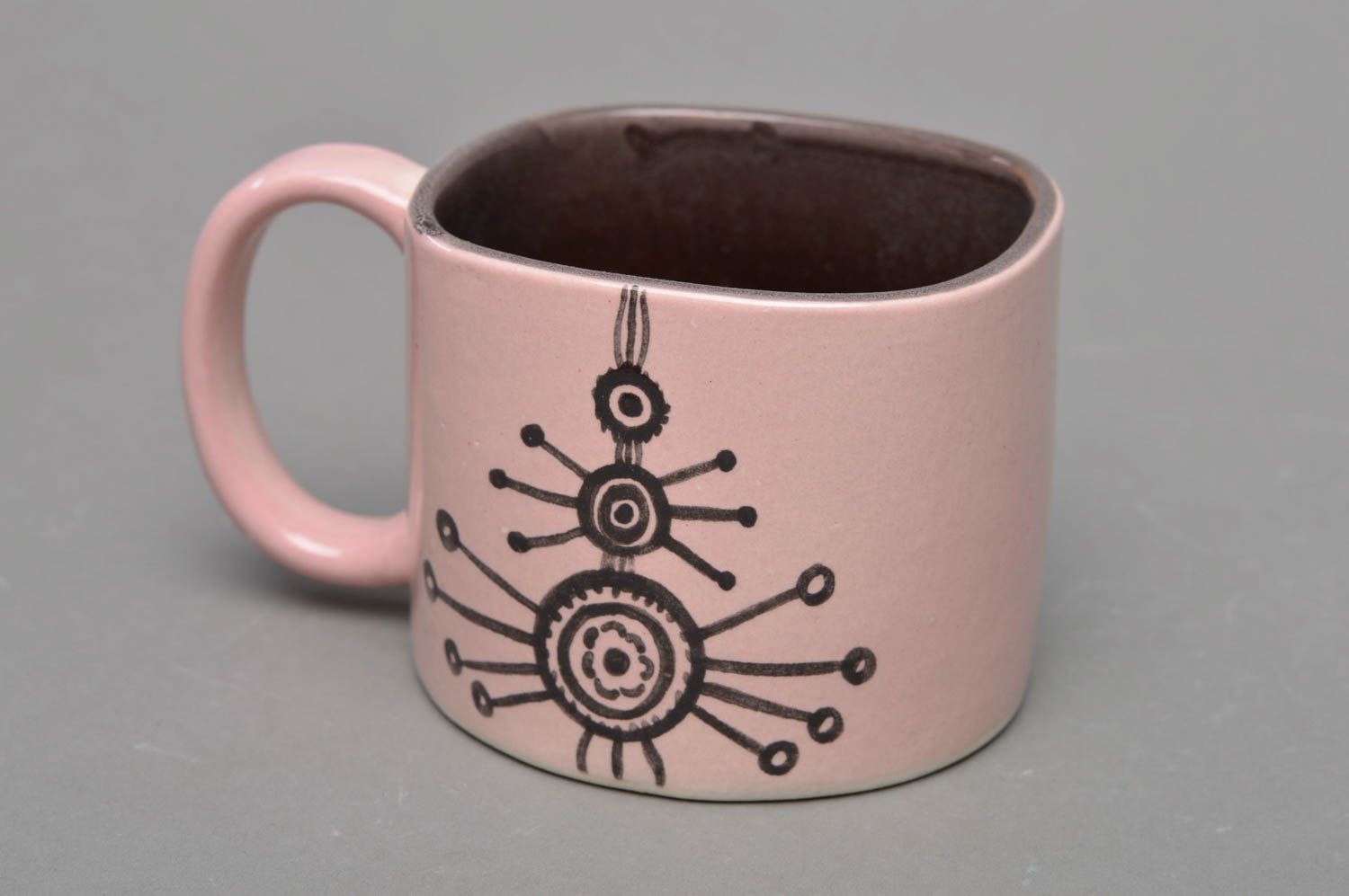 Pink and brown porcelain glazed cup with cave drawings photo 1