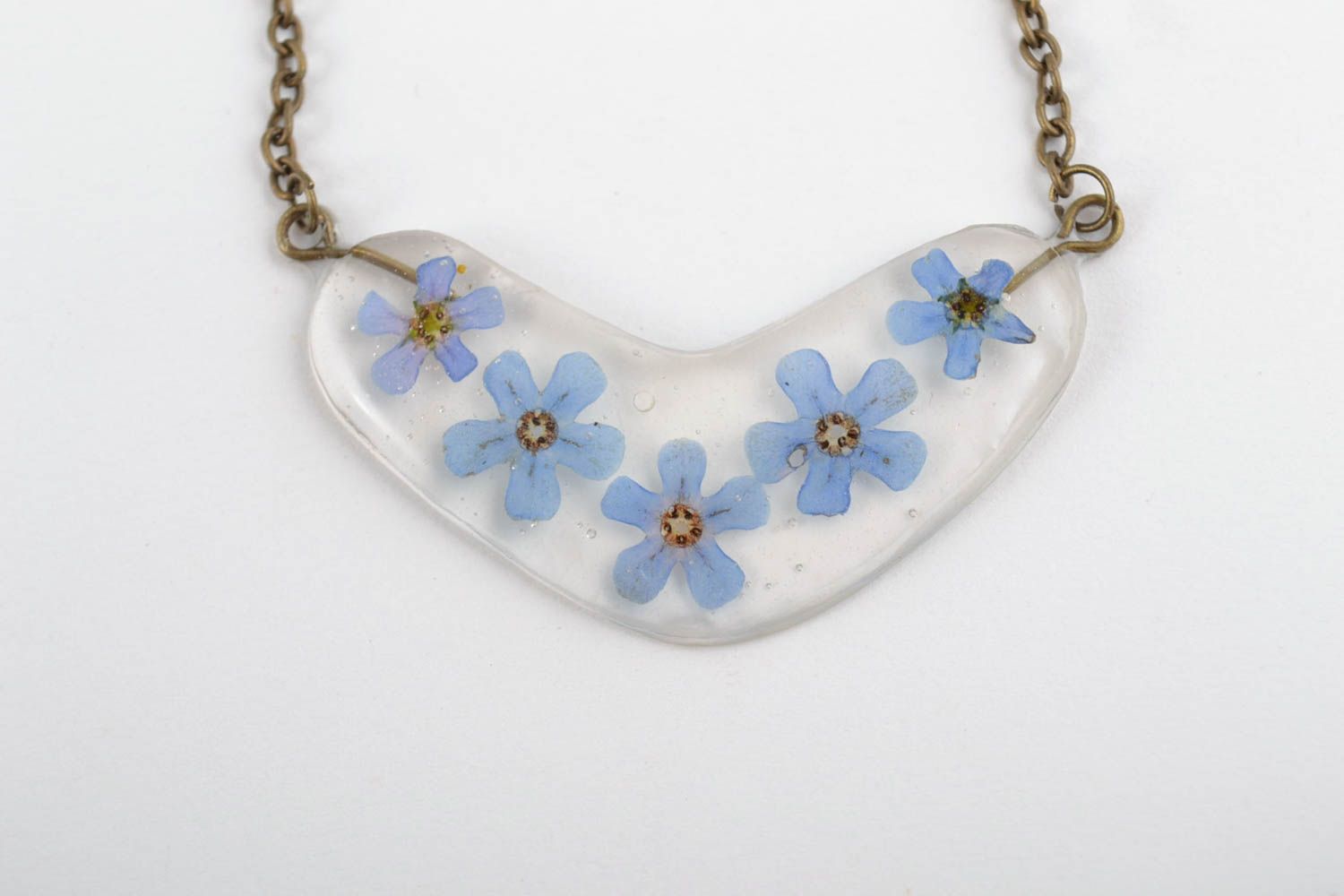 Tender handmade transparent epoxy resin pendant with blue flowers on metal chain photo 2