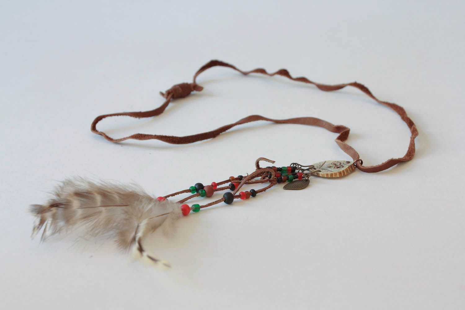 Pendant made of deer antler and feathers photo 3