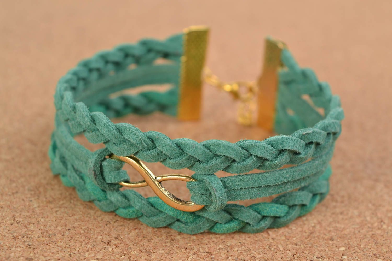 Handmade multi row suede cord woven wrist bracelet of turquoise color with charm photo 1