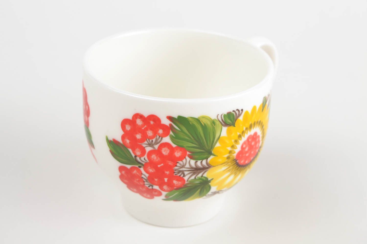 White porcelain handmade teacup with bright Russian-style floral pattern in green, red, and yellow color photo 5