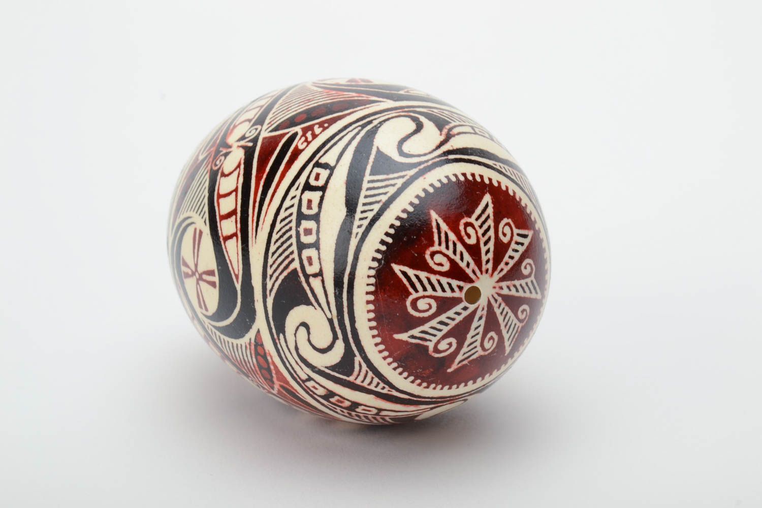 Handmade painted goose egg of black white and red colors ornamented using waxing technique photo 4