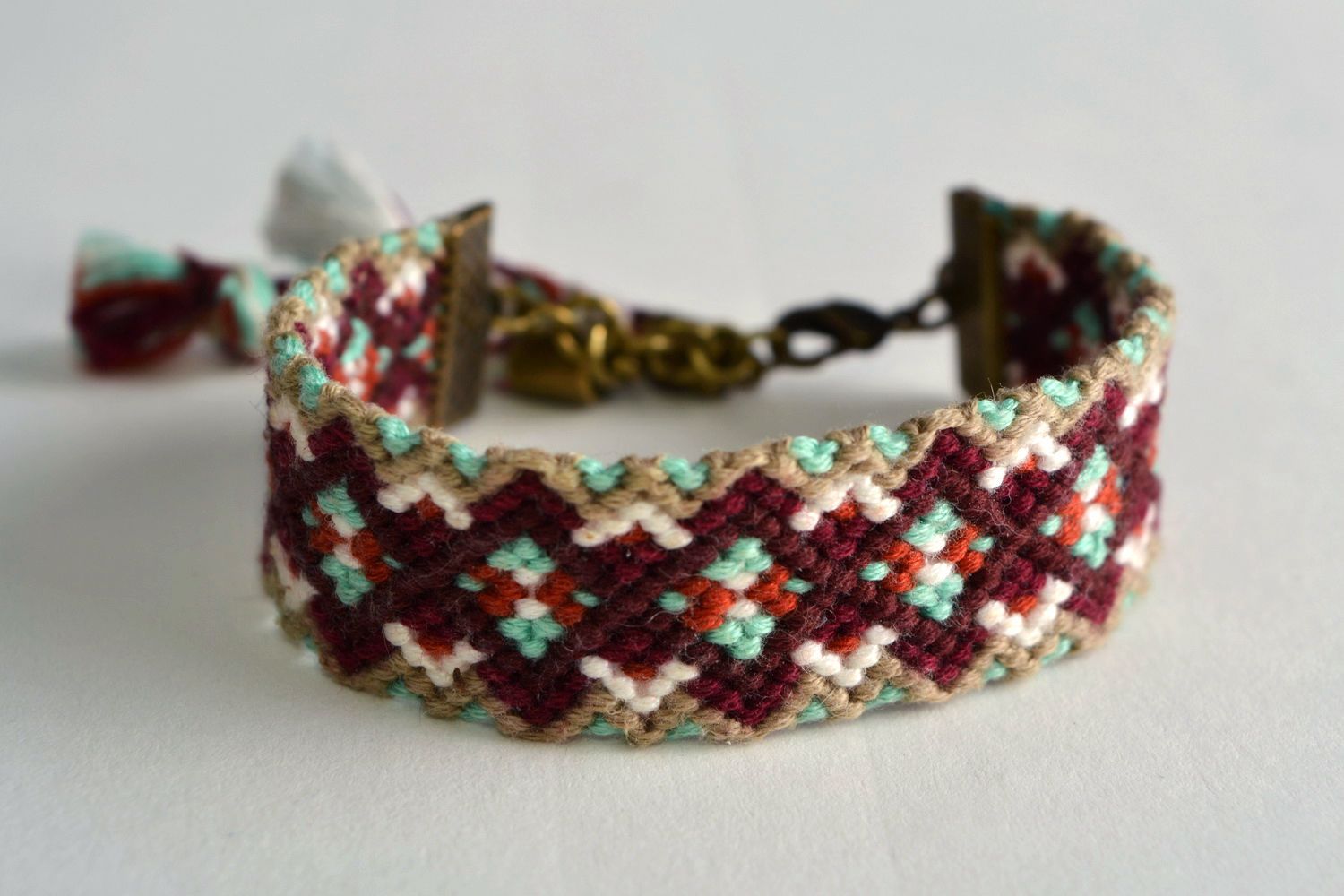 Handmade colorful friendship wrist bracelet woven using macrame technique photo 1