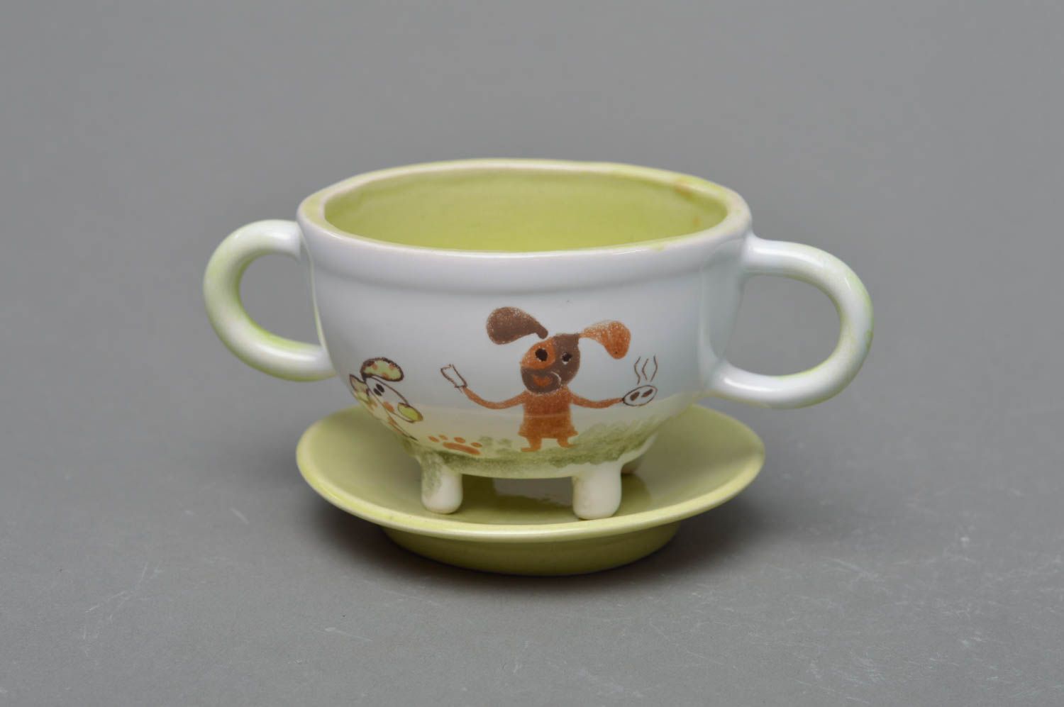 Handmade porcelain 5 oz kid drinking cup with two handles, legs, and a saucer photo 1